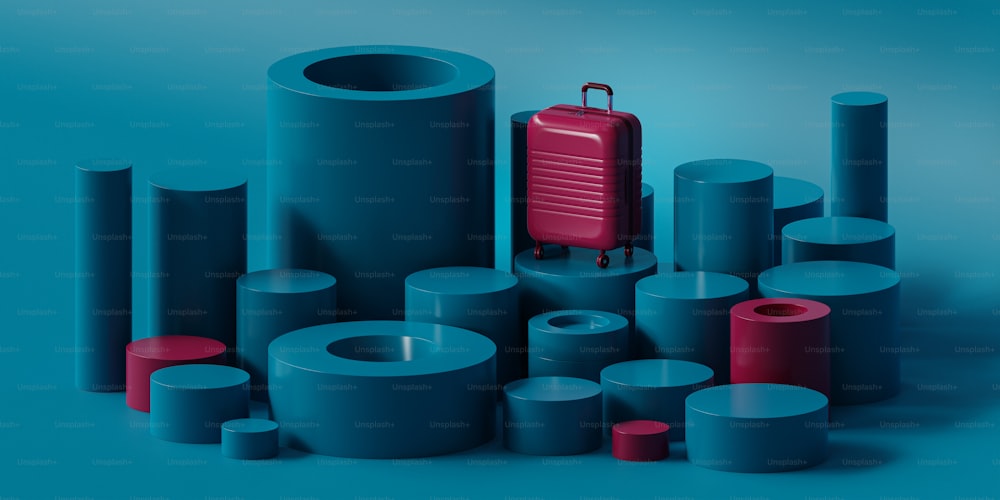 a red suitcase sitting on top of a pile of blue cylinders