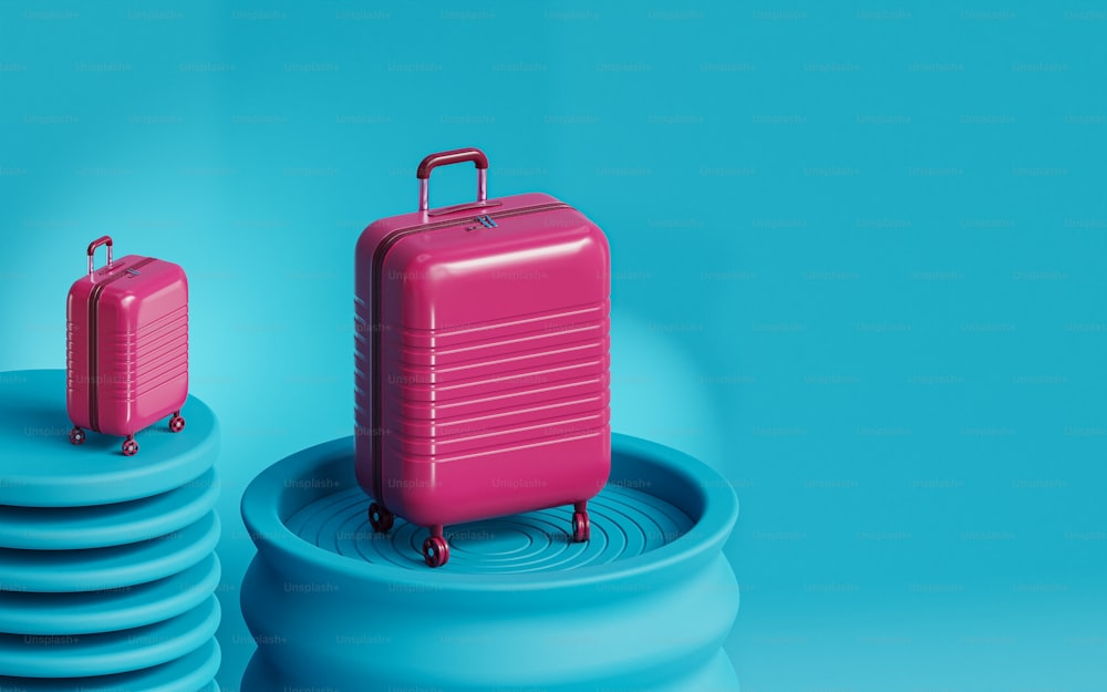a pink piece of luggage sitting on top of a stack of blue discs