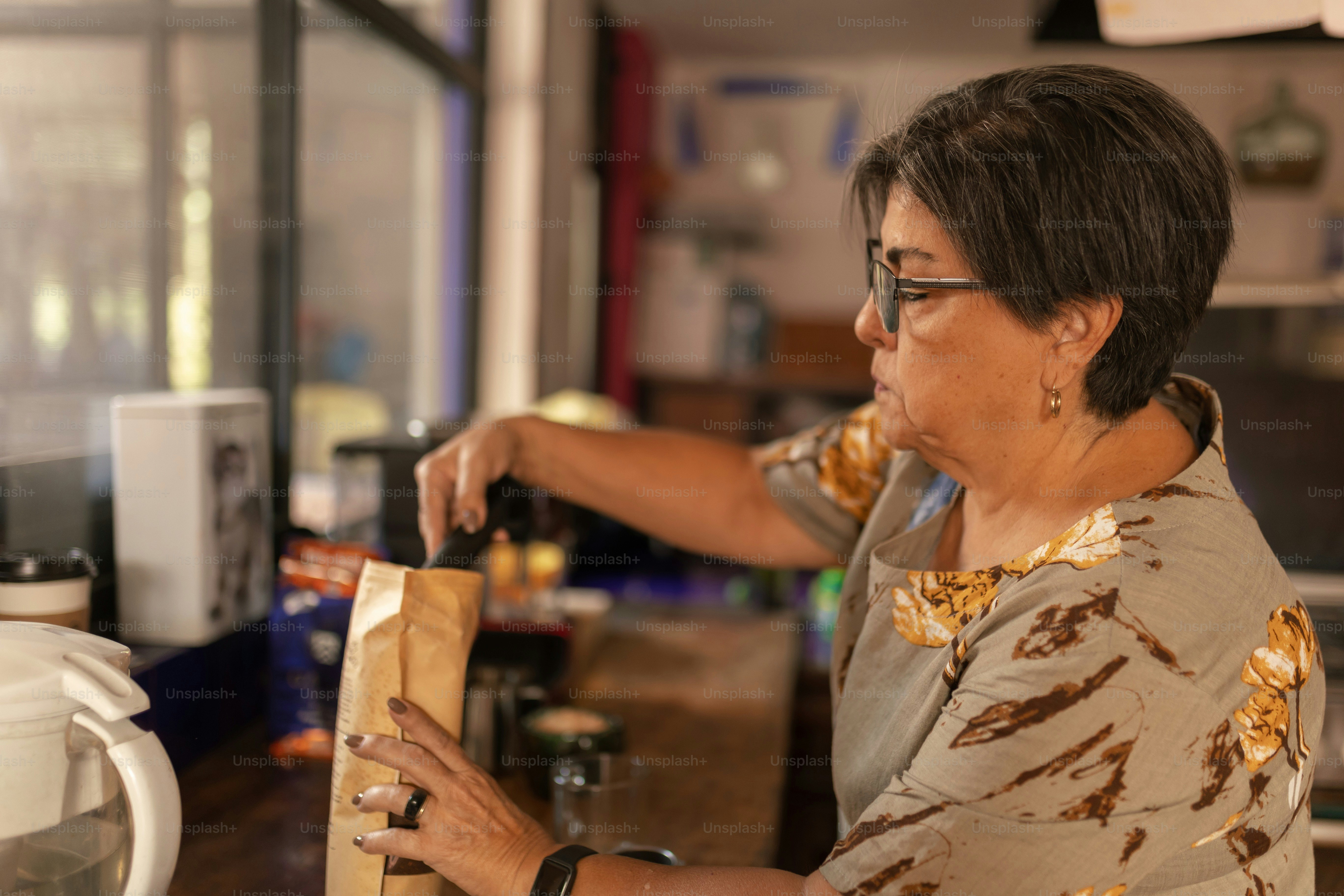 a woman standing in a kitchen preparing food