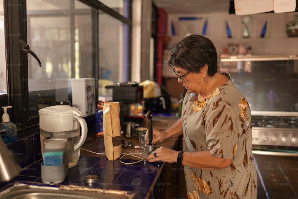 a woman standing in a kitchen preparing food