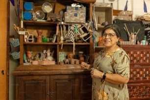 a woman standing in front of a wooden cabinet