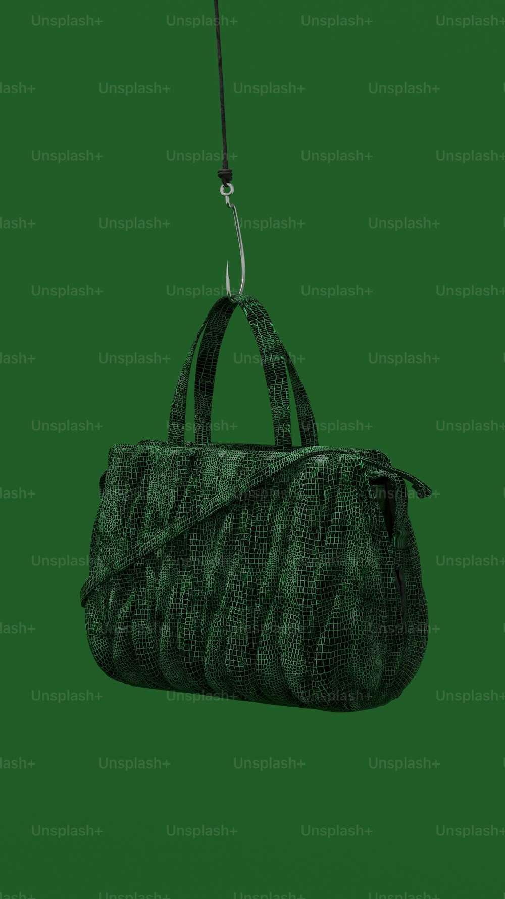 a handbag hanging from a string on a green background