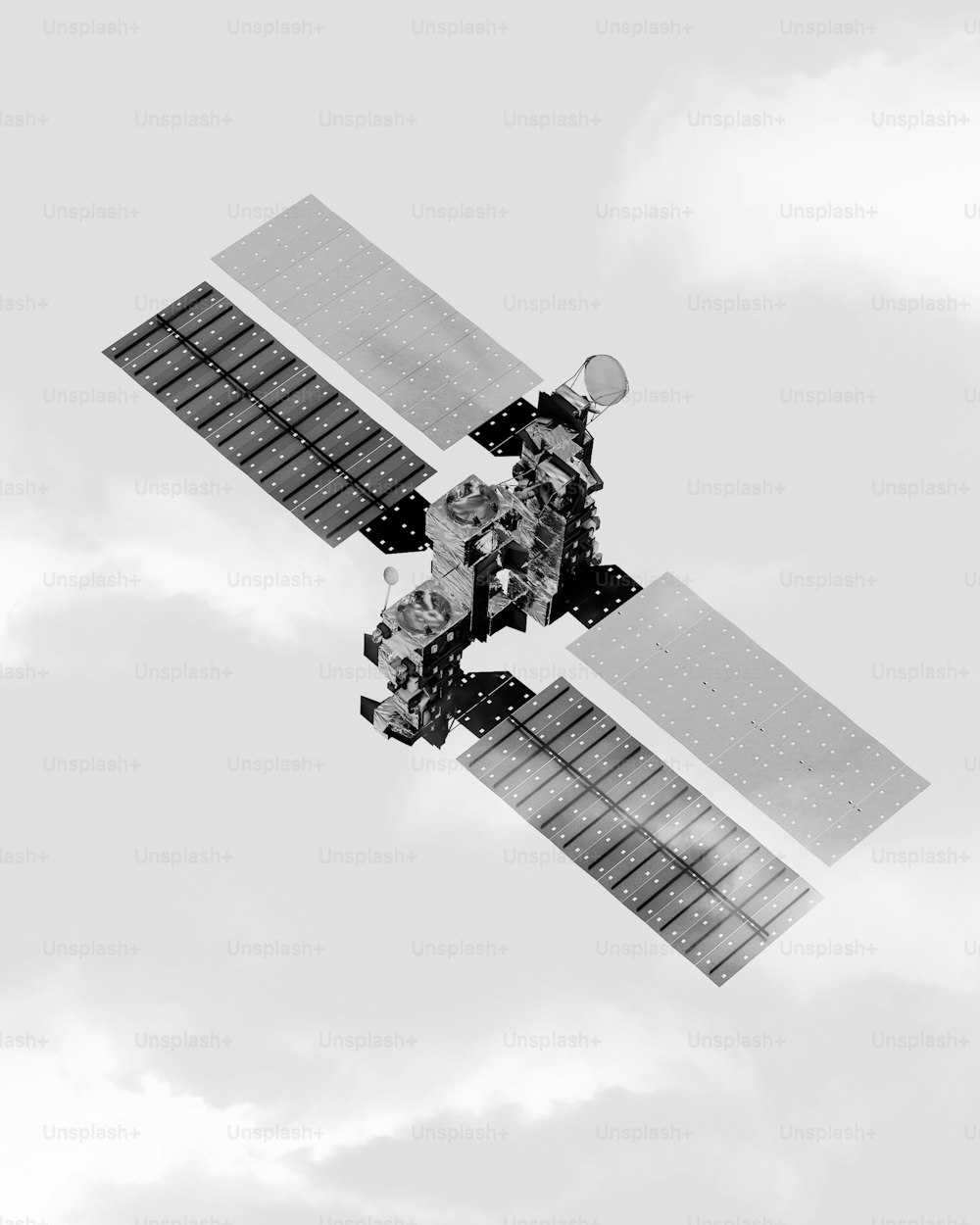 a black and white photo of a satellite in the sky