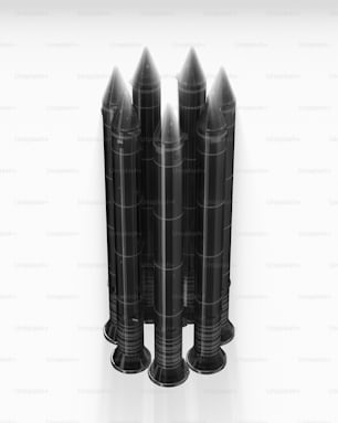 a group of black candles sitting on top of each other