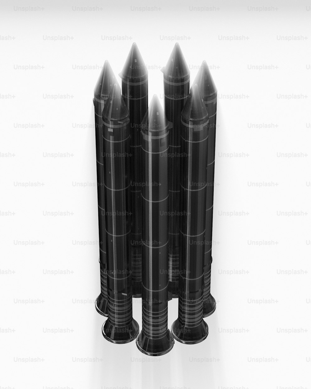 a group of black candles sitting on top of each other