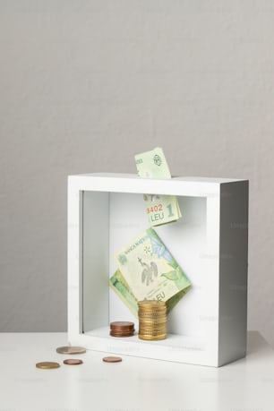 a white box with money inside of it