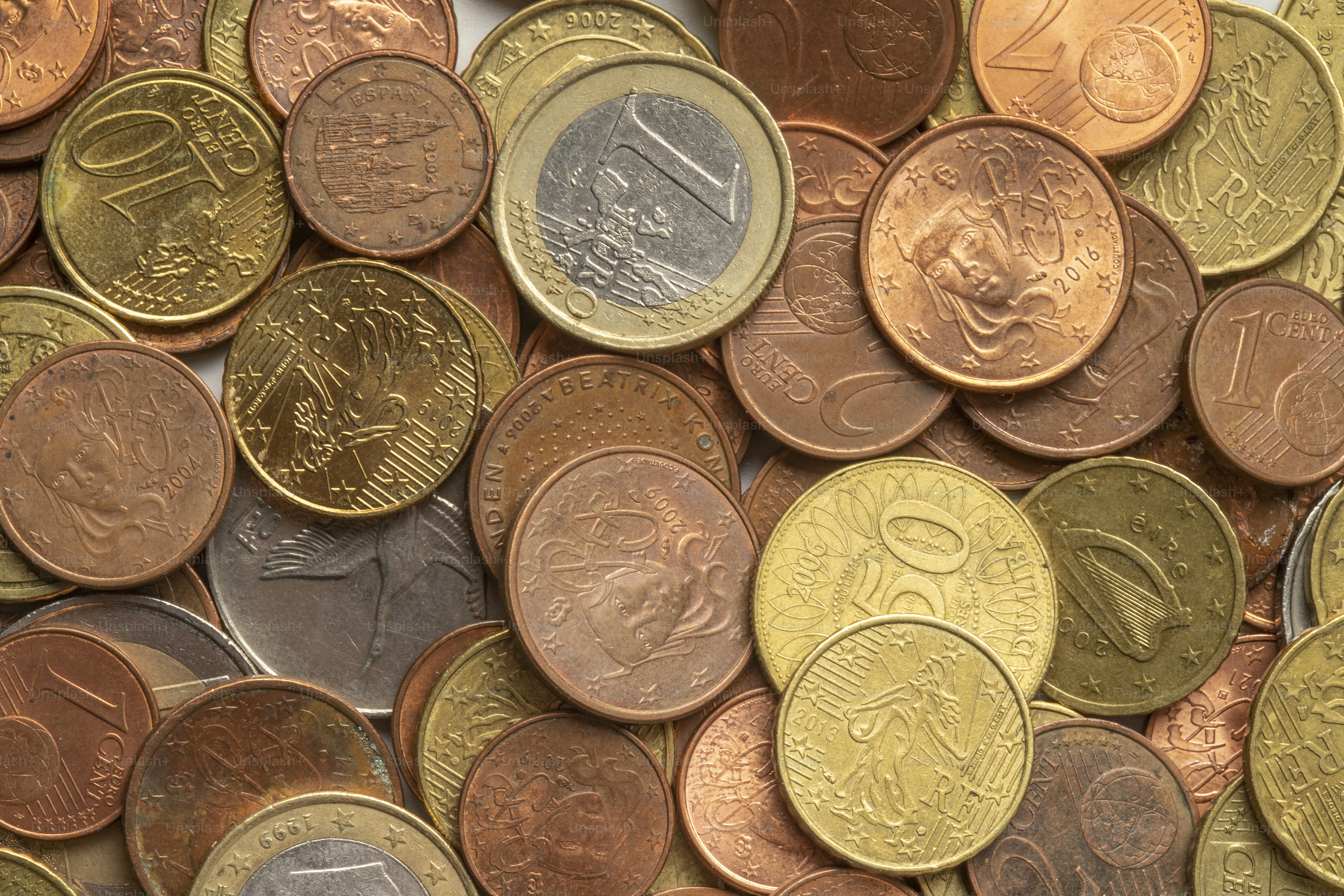 a pile of different types of coins