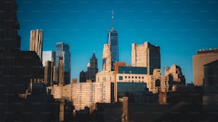 a city skyline with tall buildings and a blue sky