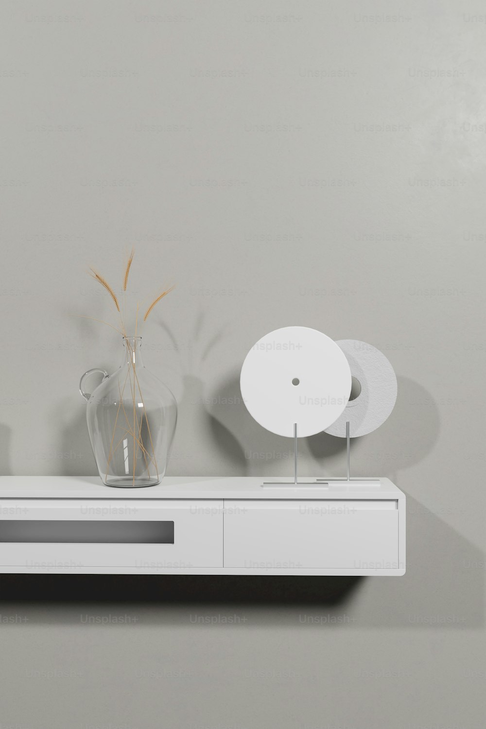 a white table with a vase and a fan on top of it