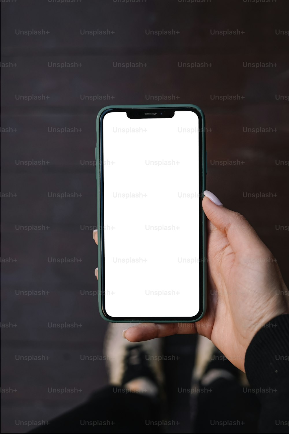 a person holding a cell phone with a white screen