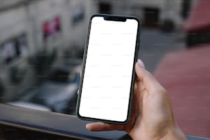 a person holding a cell phone with a white screen