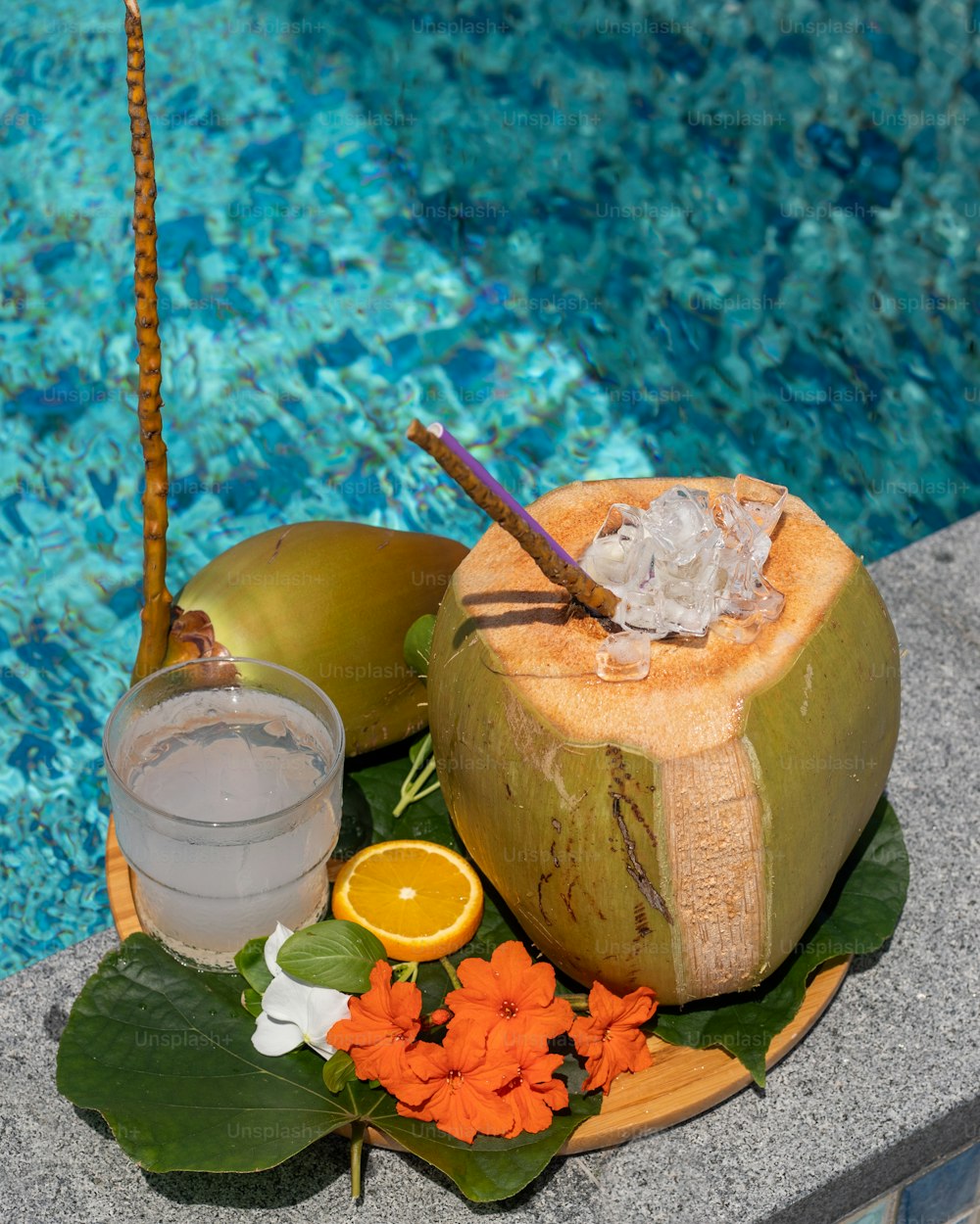 a plate of food next to a swimming pool