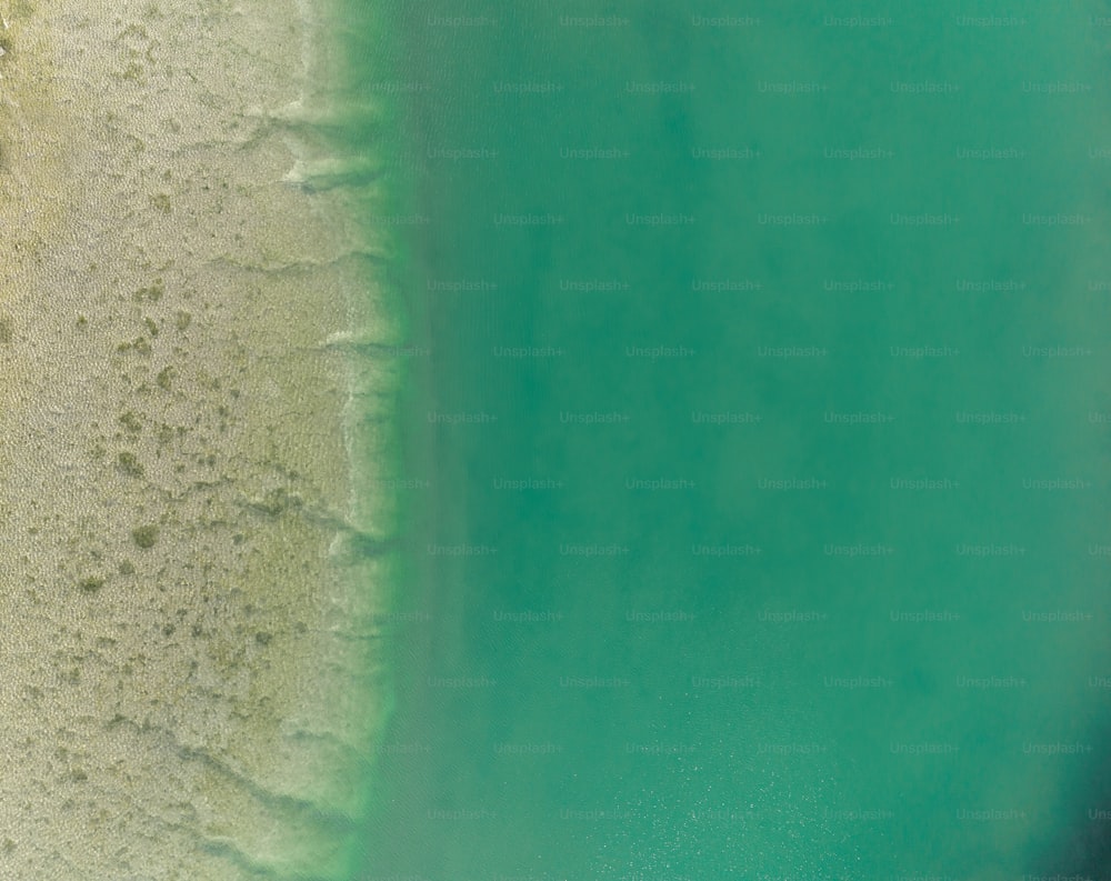 an aerial view of a sandy beach and ocean