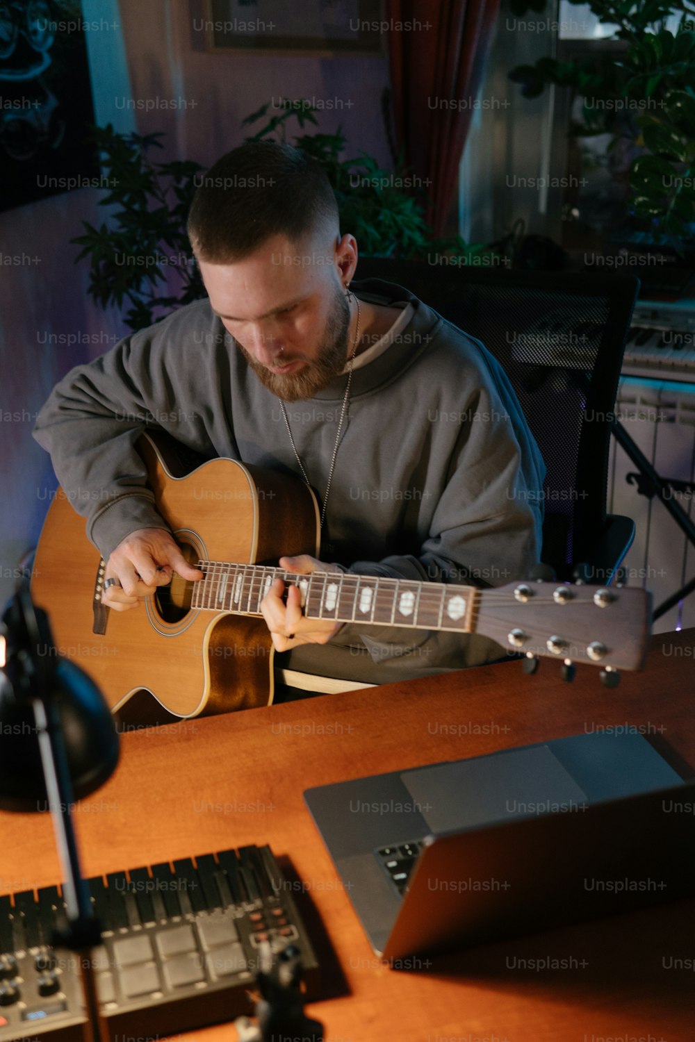 a man sitting at a table playing a guitar