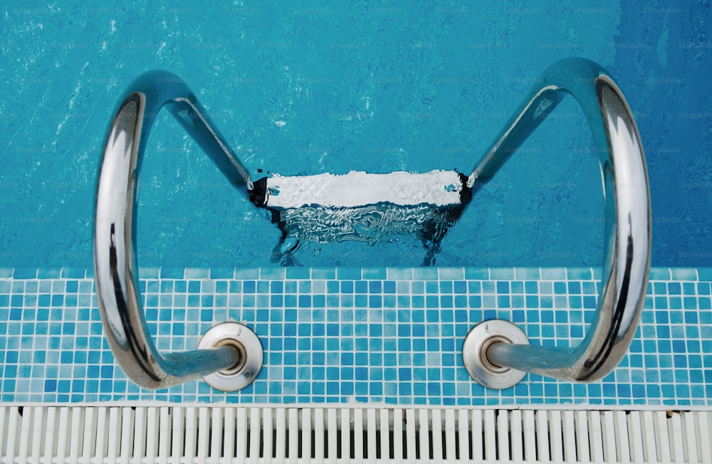 a swimming pool with a metal hand rail