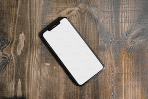 a cell phone sitting on top of a wooden table