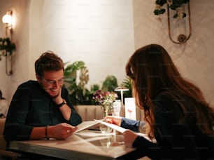 a man and a woman sitting at a table