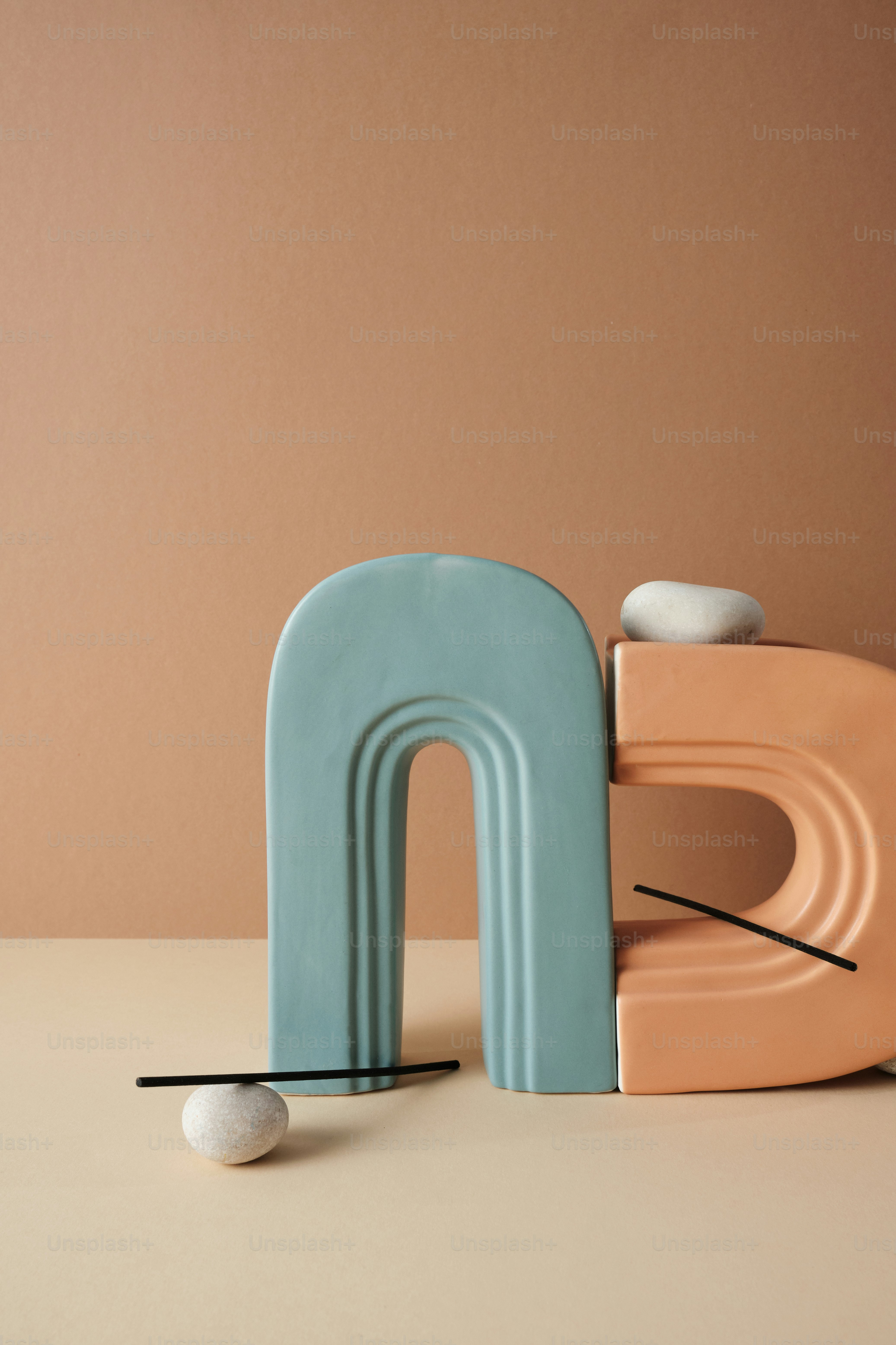 a sculpture of a letter and a golf ball on a table