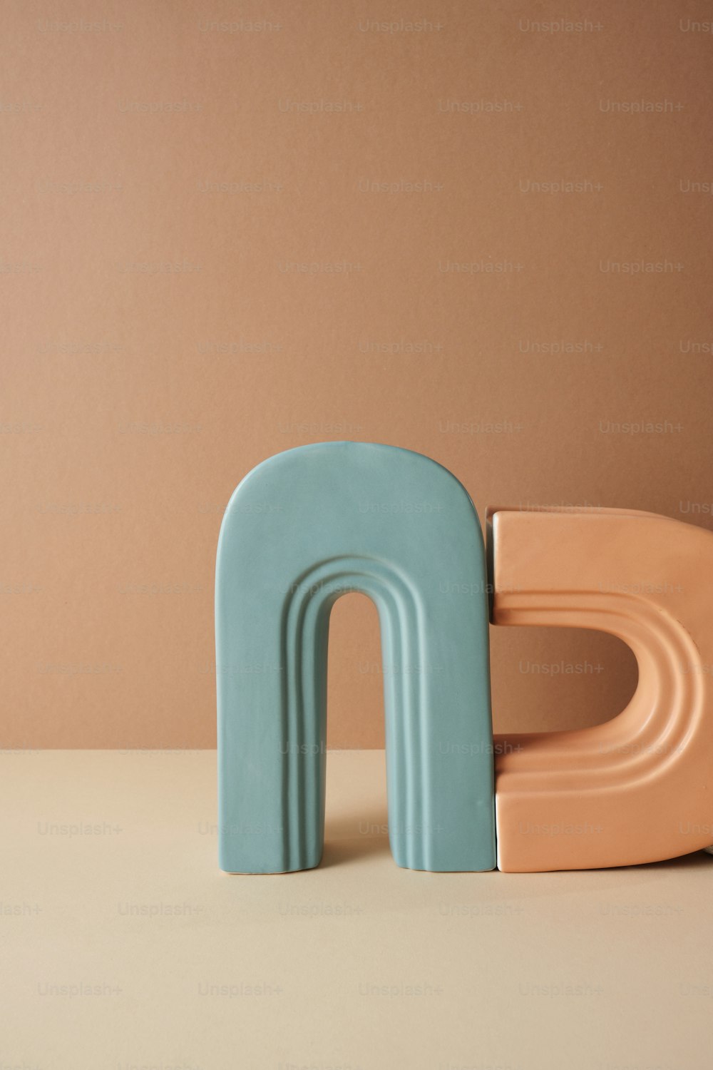 a blue and pink letter sitting on top of a table