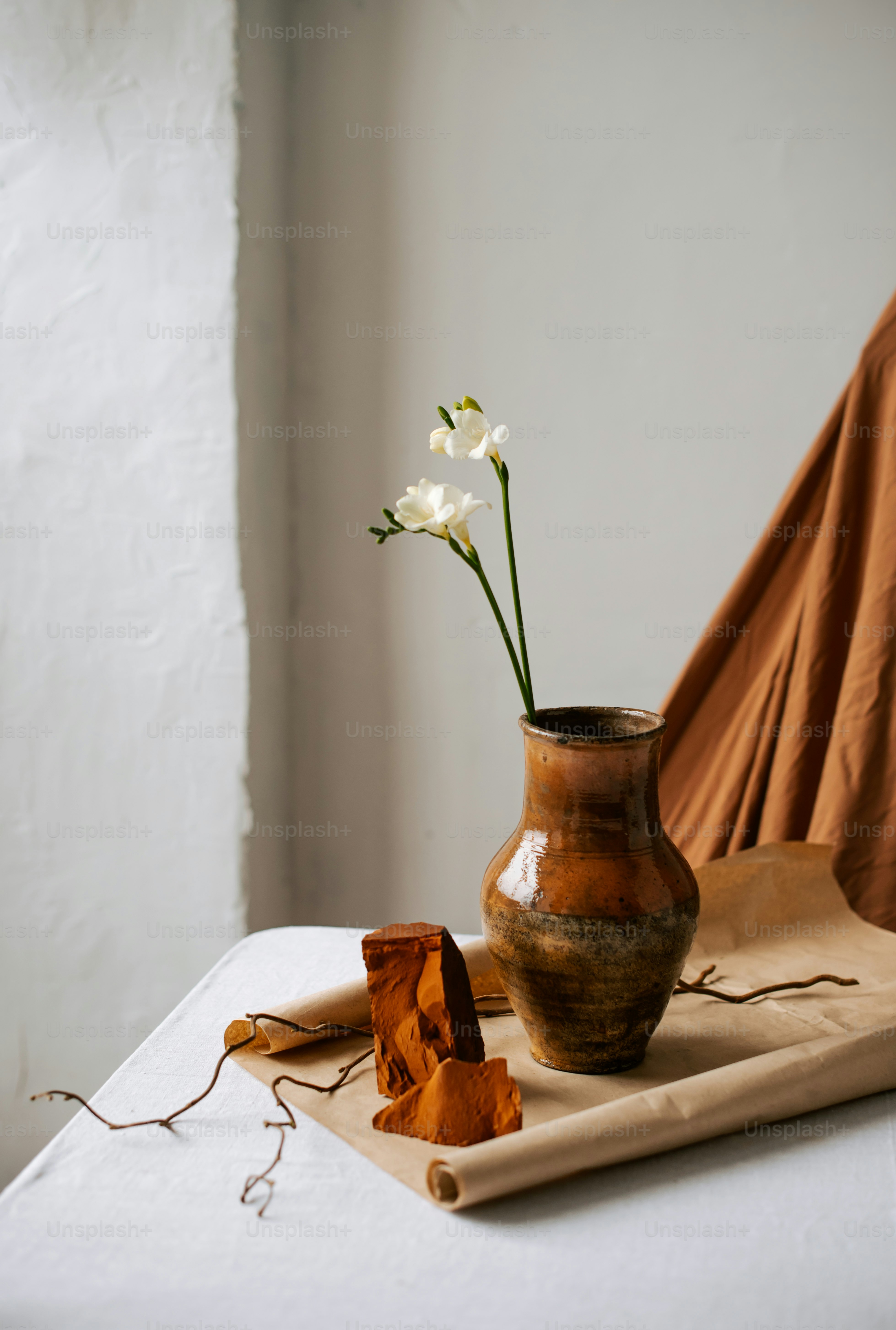 a vase with a flower in it sitting on a table