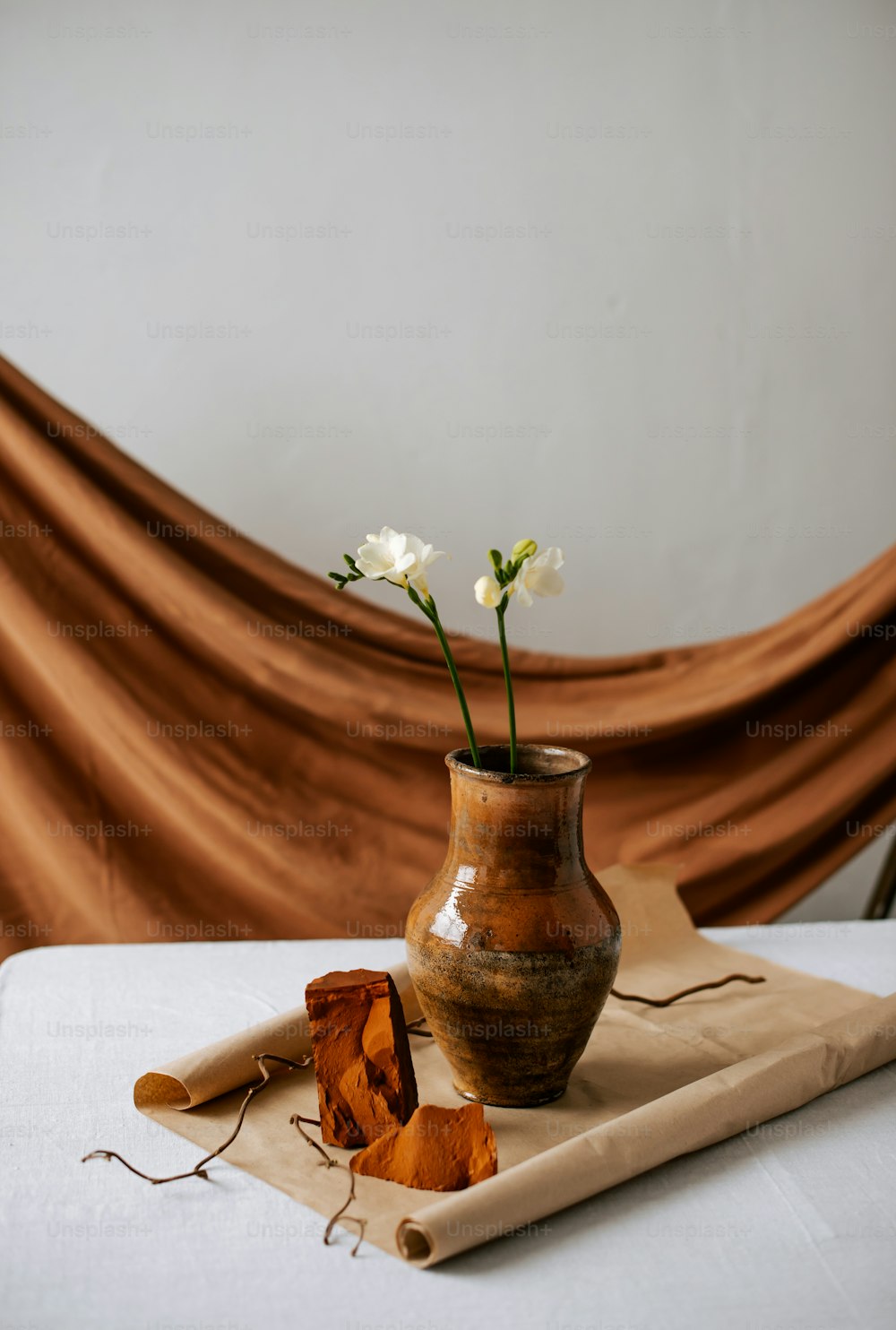 a vase with a flower in it sitting on a table