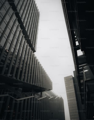 a black and white photo of two tall buildings