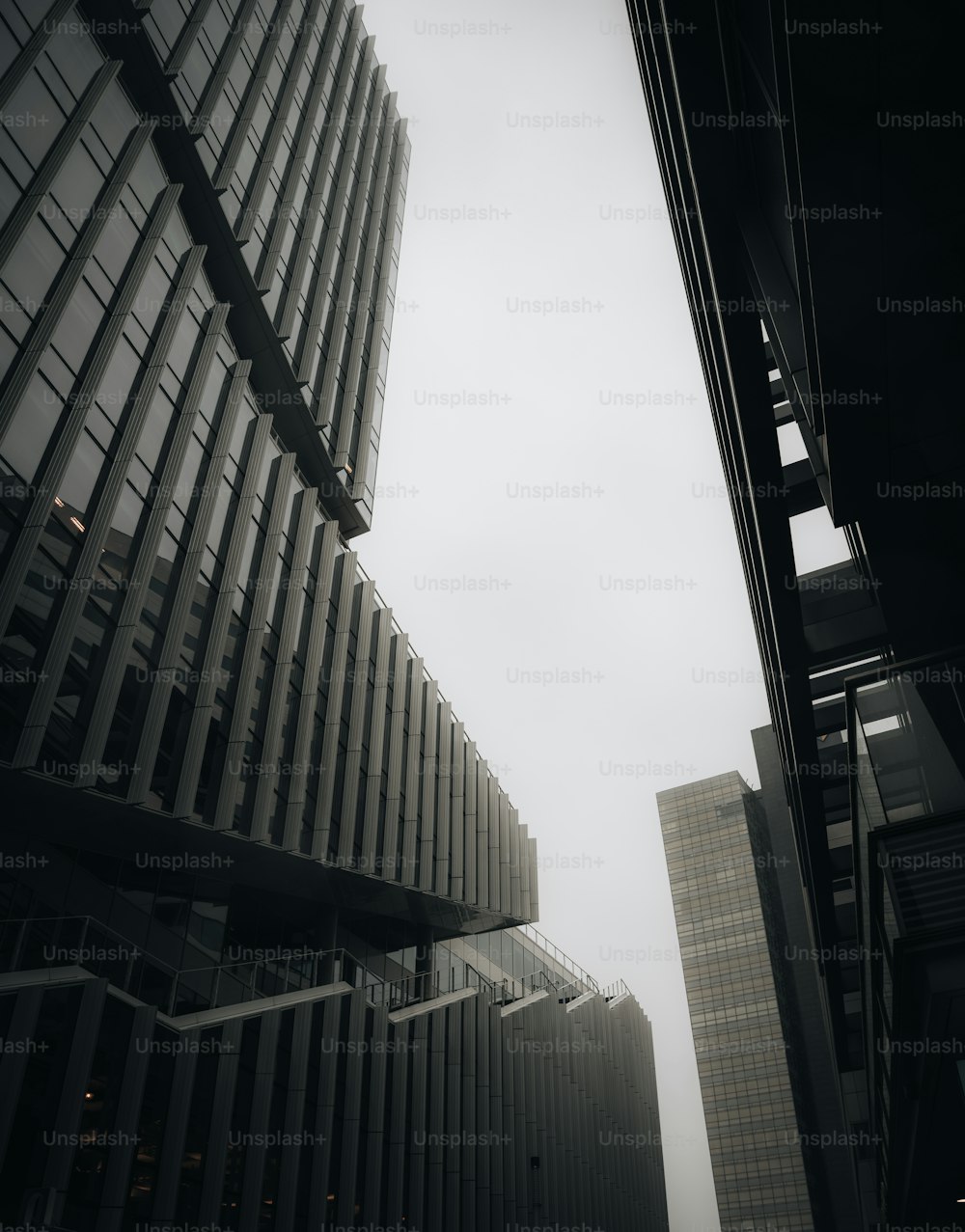 a black and white photo of two tall buildings