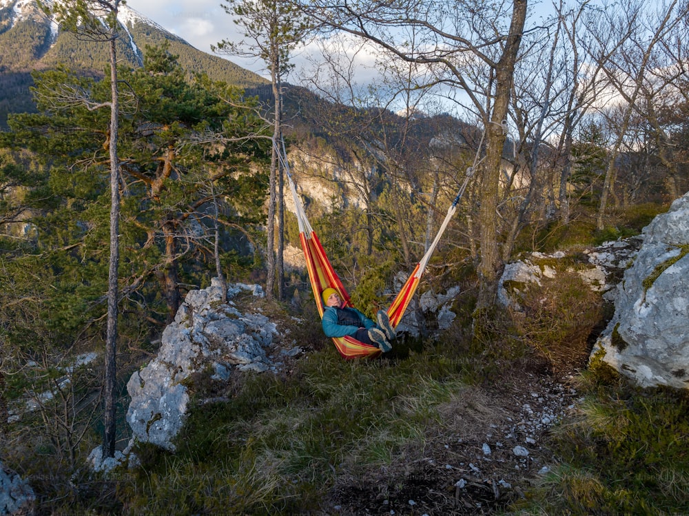 a hammock hanging from a tree in the mountains