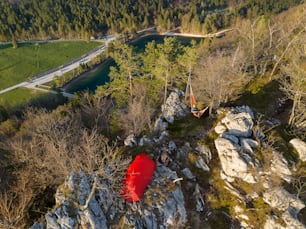 a red canoe is sitting on a rocky cliff
