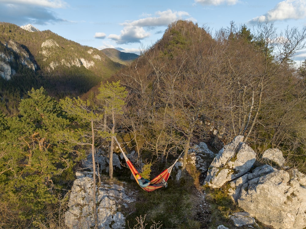 a hammock hanging between two large rocks