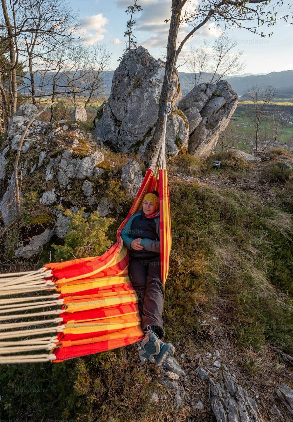 a man sitting in a hammock on a mountain