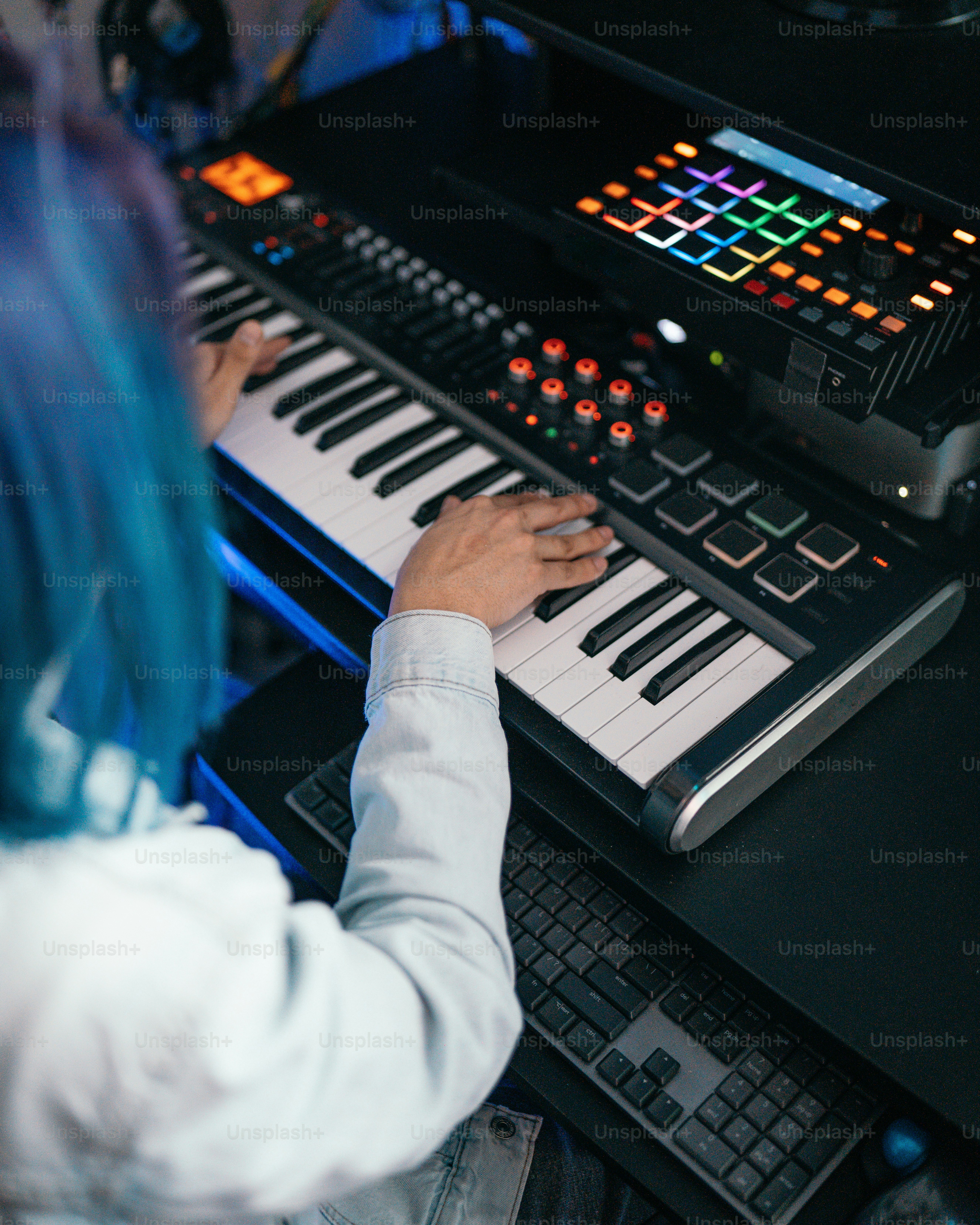 a person sitting at a keyboard playing a musical instrument