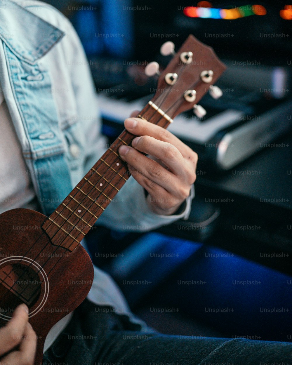 a person holding a ukulele in their hands