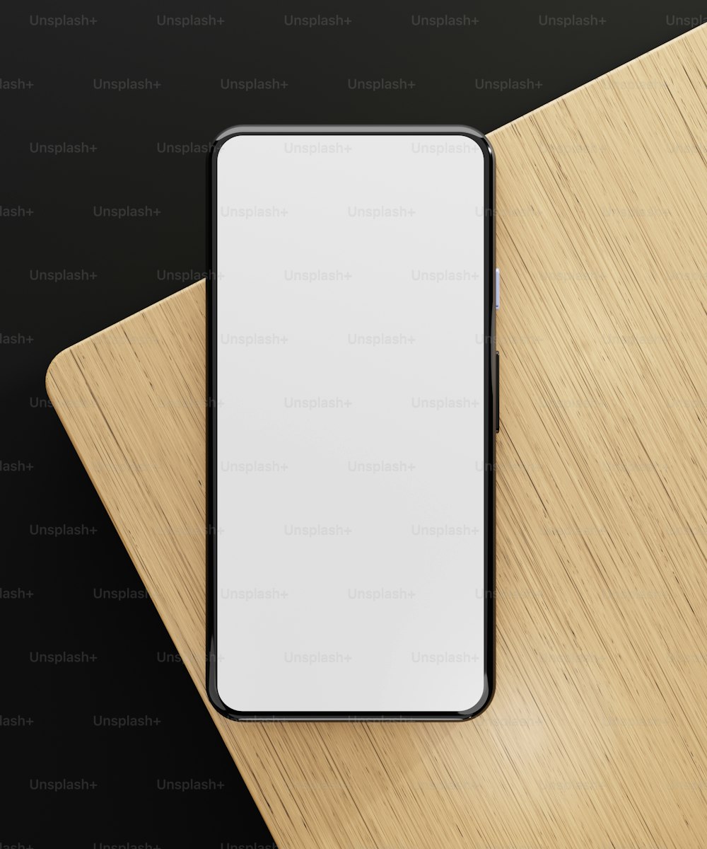 un téléphone portable blanc et noir posé sur une table en bois