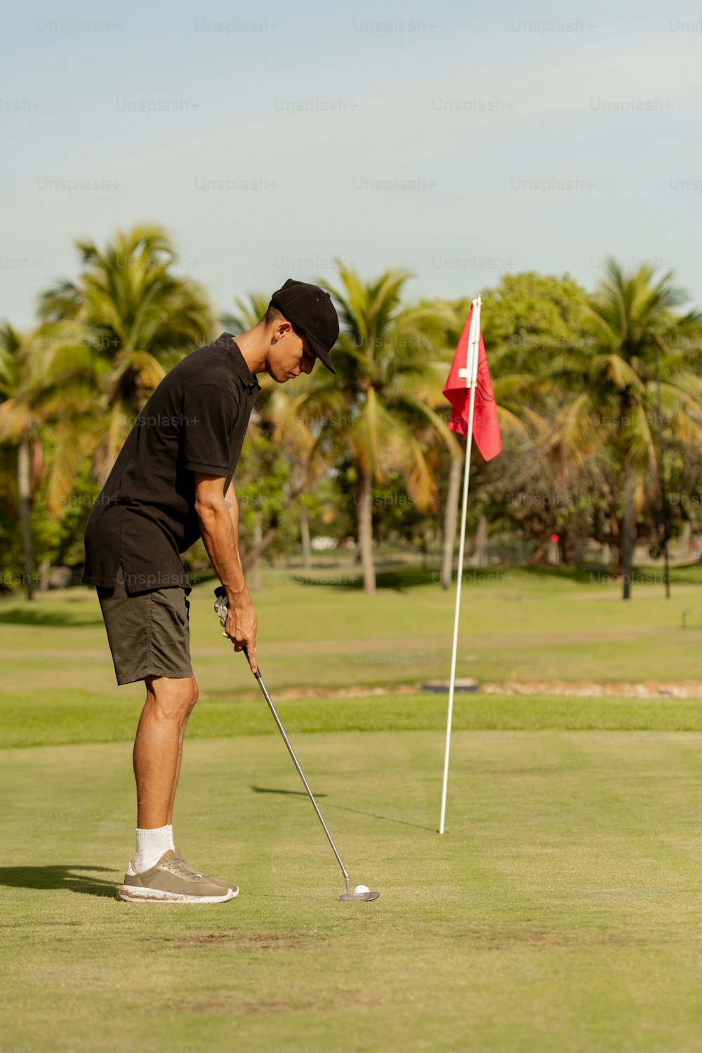 a man putting a golf ball on the green