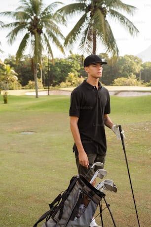 a man holding a golf bag and golf clubs