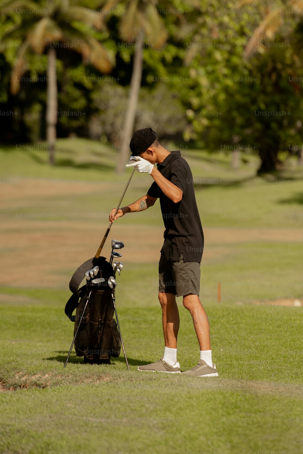 a man putting a golf club in a golf bag