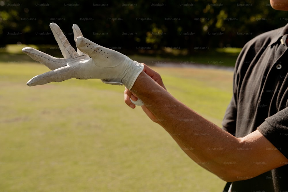 a man holding a white glove in his hand