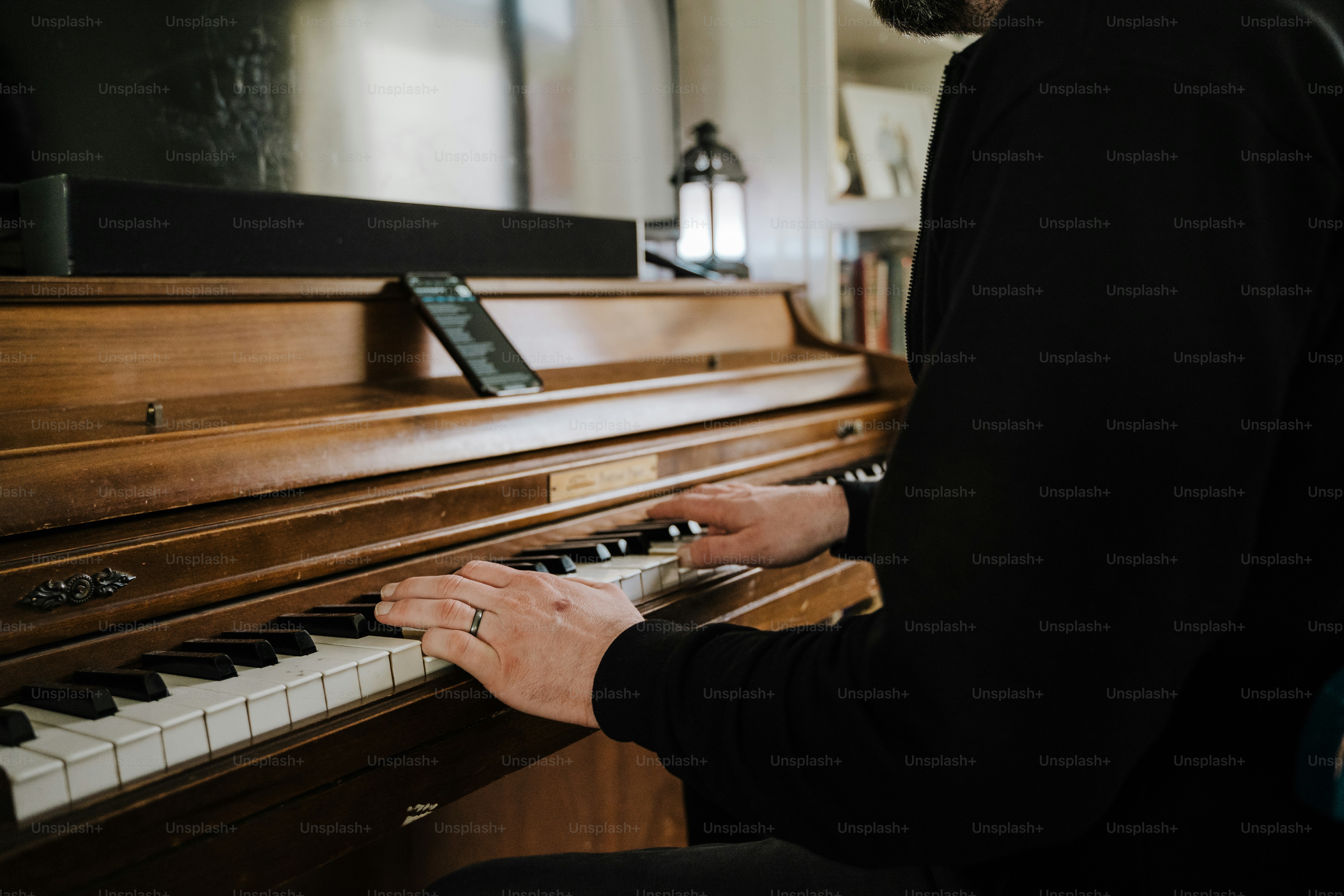 a man playing a piano in a living room