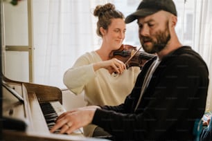 a man and a woman playing the violin