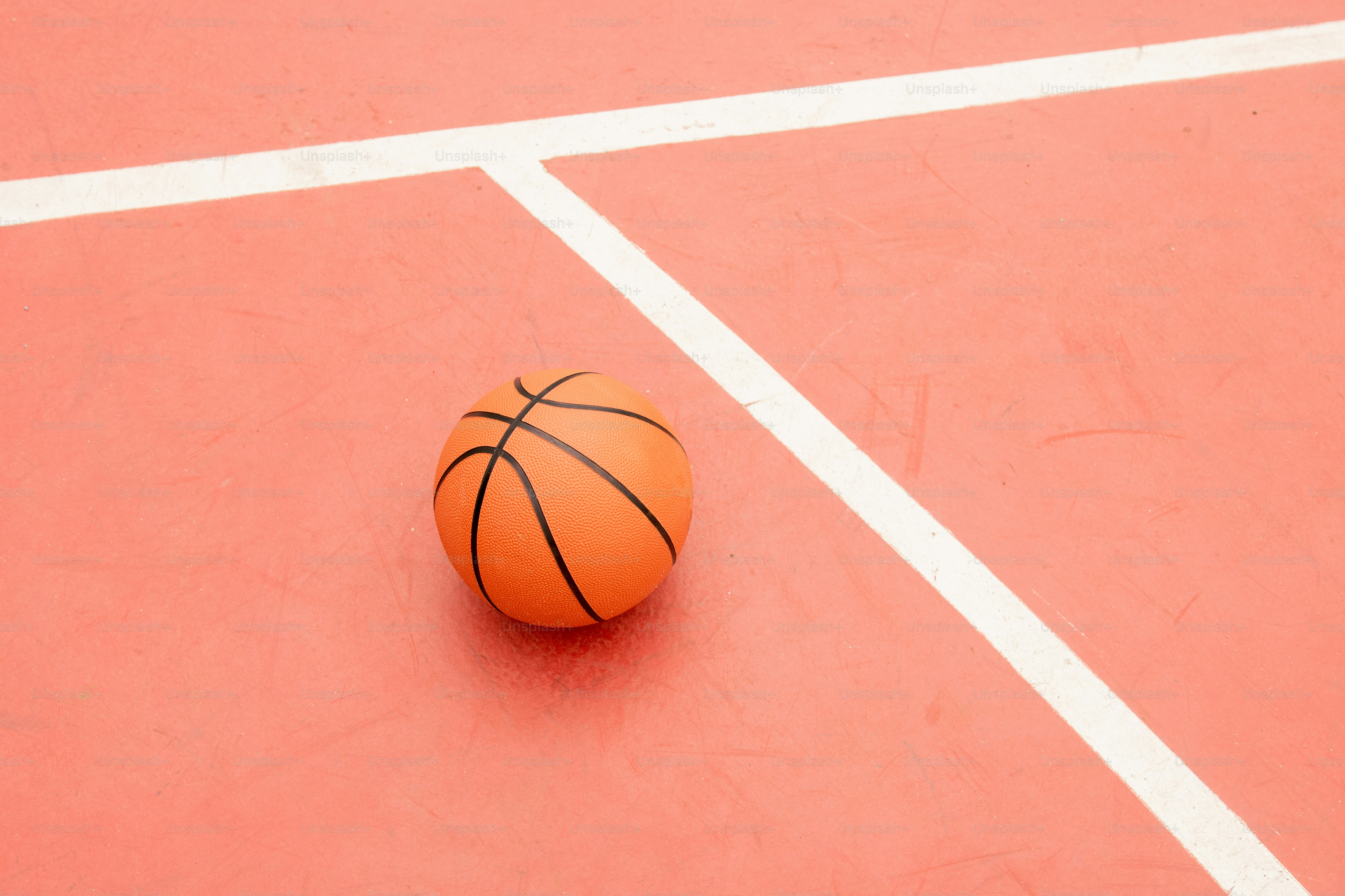 a basketball sitting on top of a basketball court