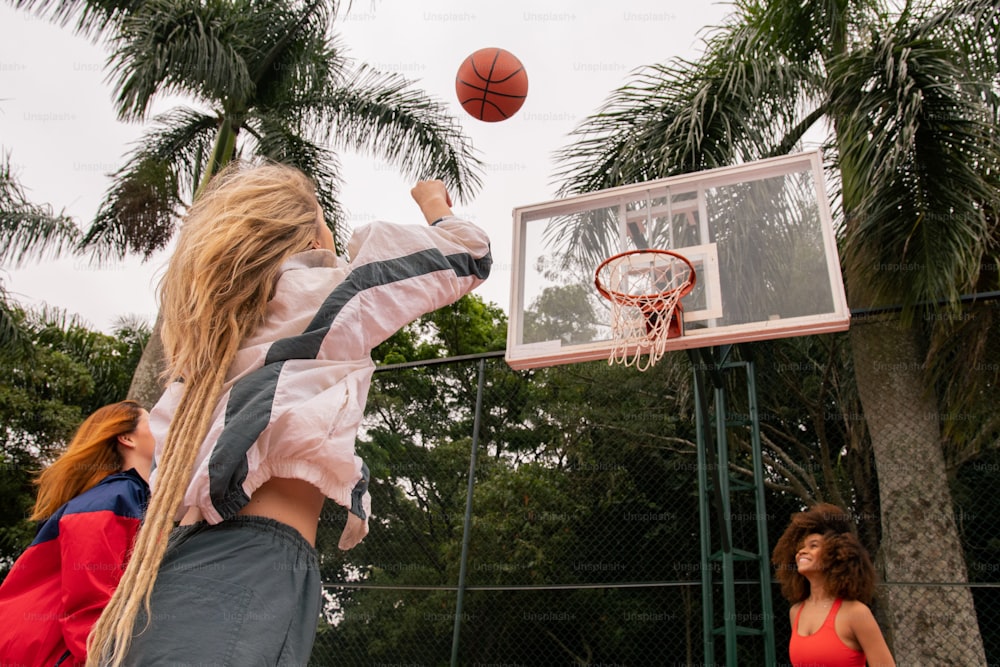 a girl is playing basketball on a court