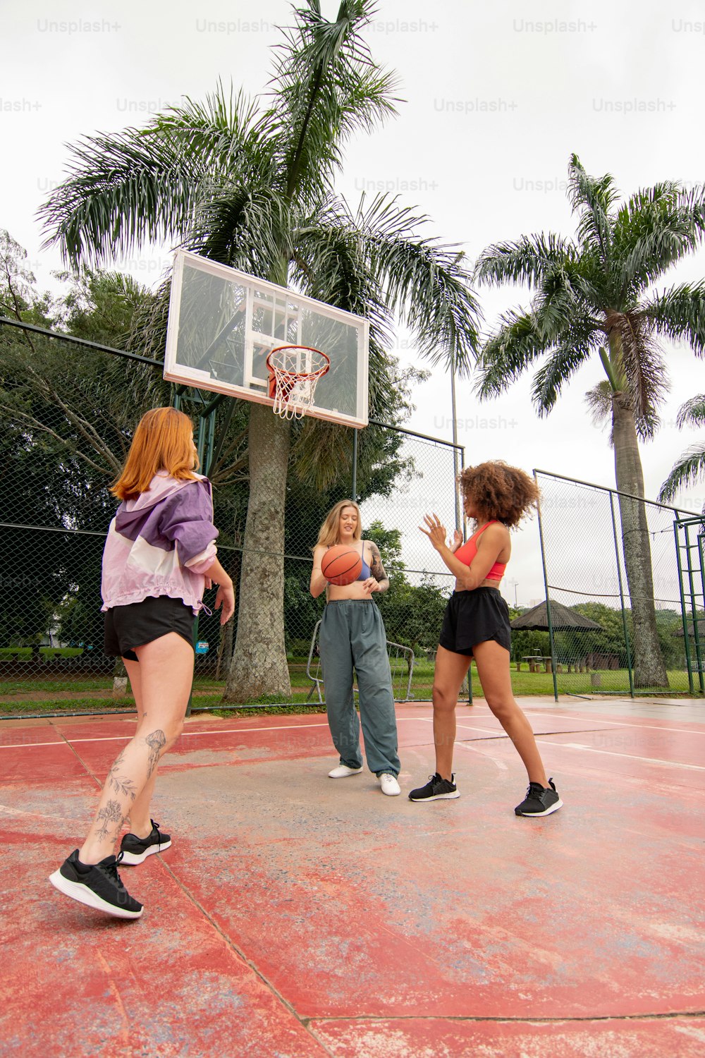 a group of young women playing a game of basketball