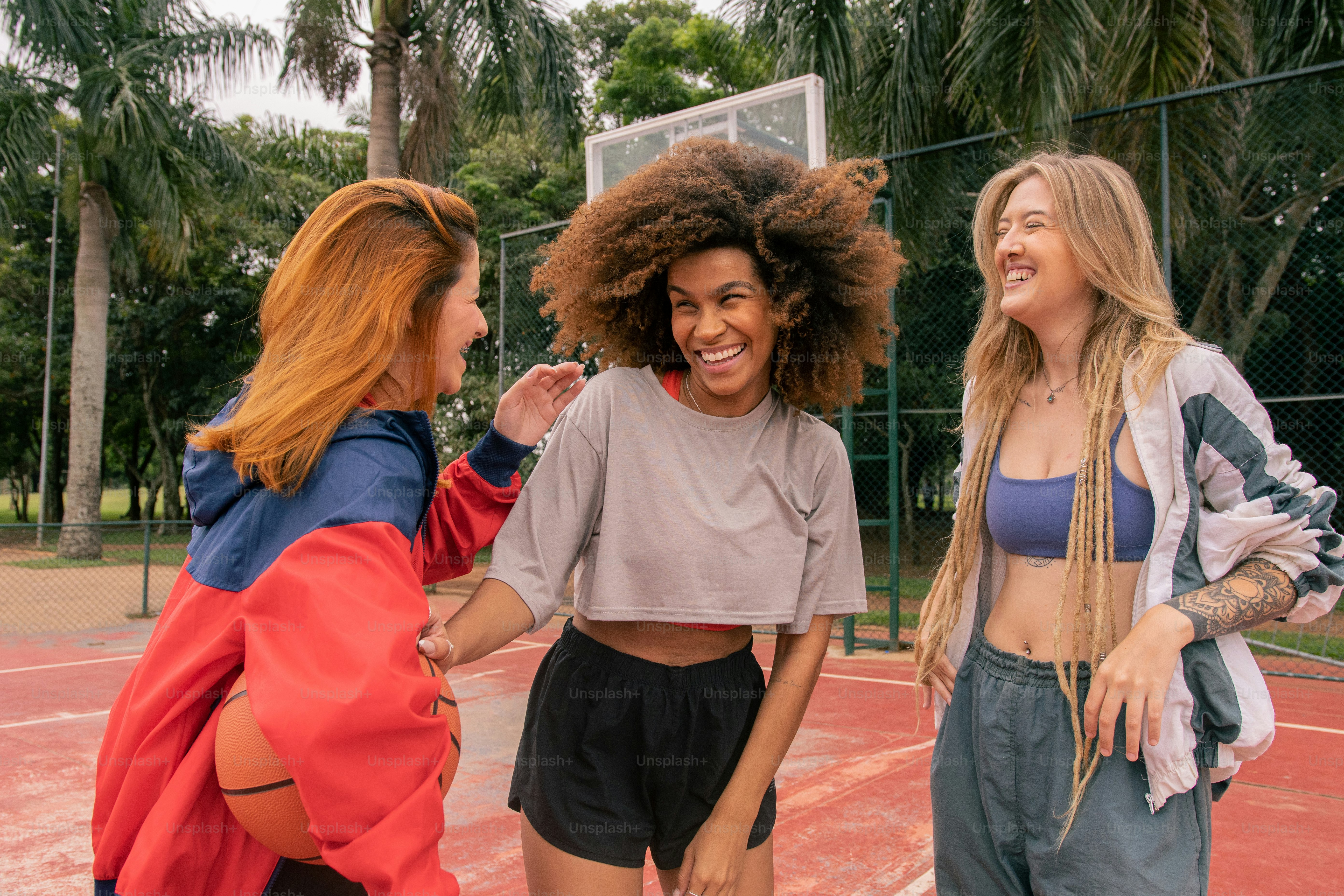 a group of women standing on top of a tennis court