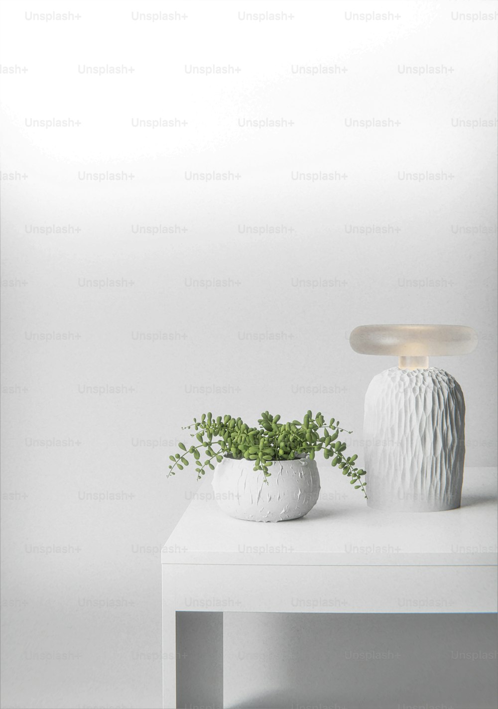 a white table topped with a white vase and a plant
