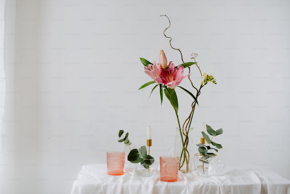 a table topped with a vase filled with flowers