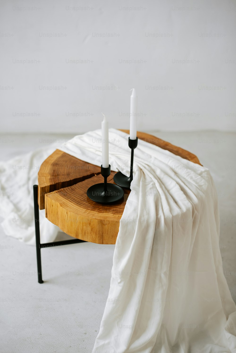 uma mesa de madeira com duas velas sobre ela