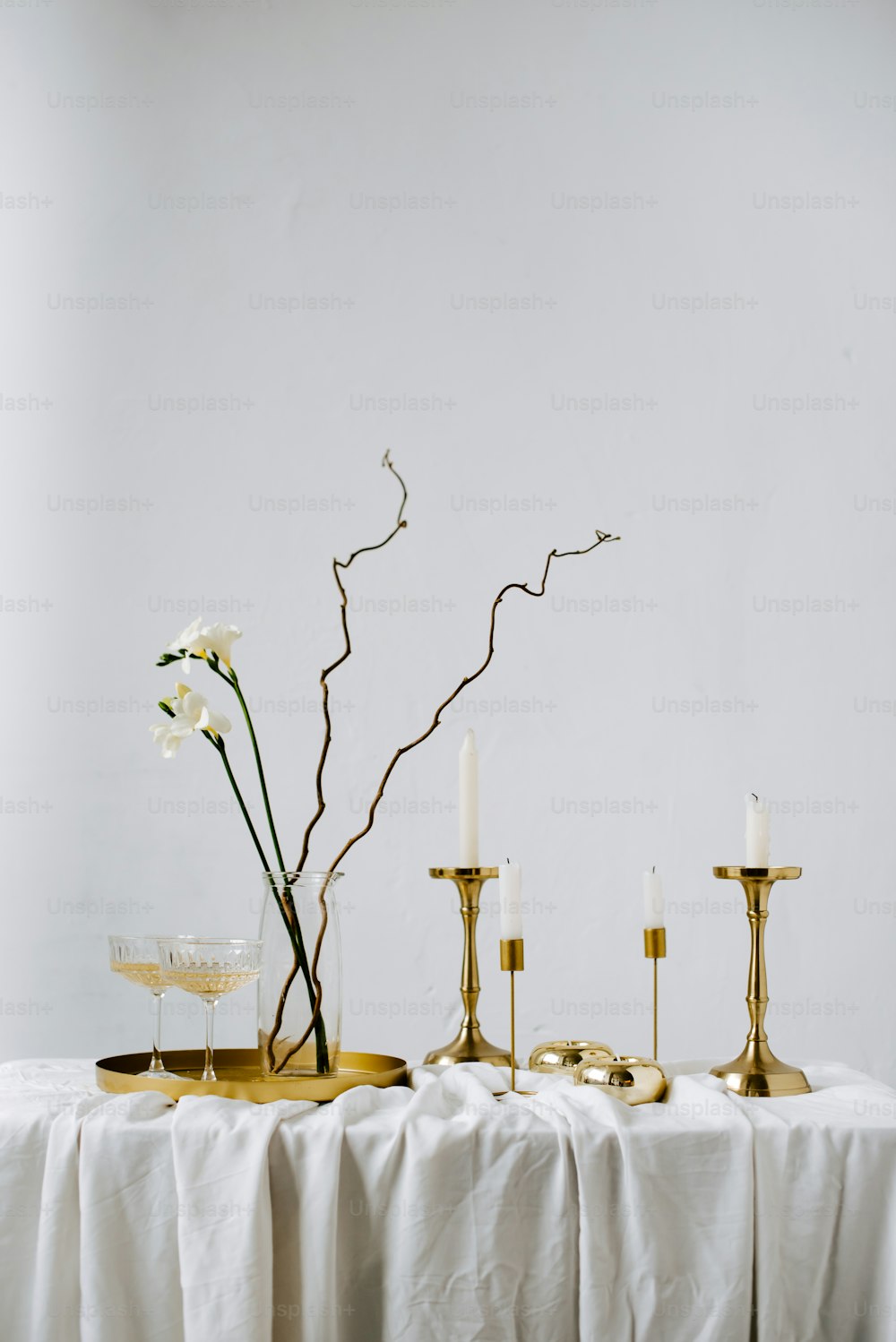 a table topped with candles and a vase filled with flowers