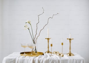 a table topped with candles and a vase filled with flowers
