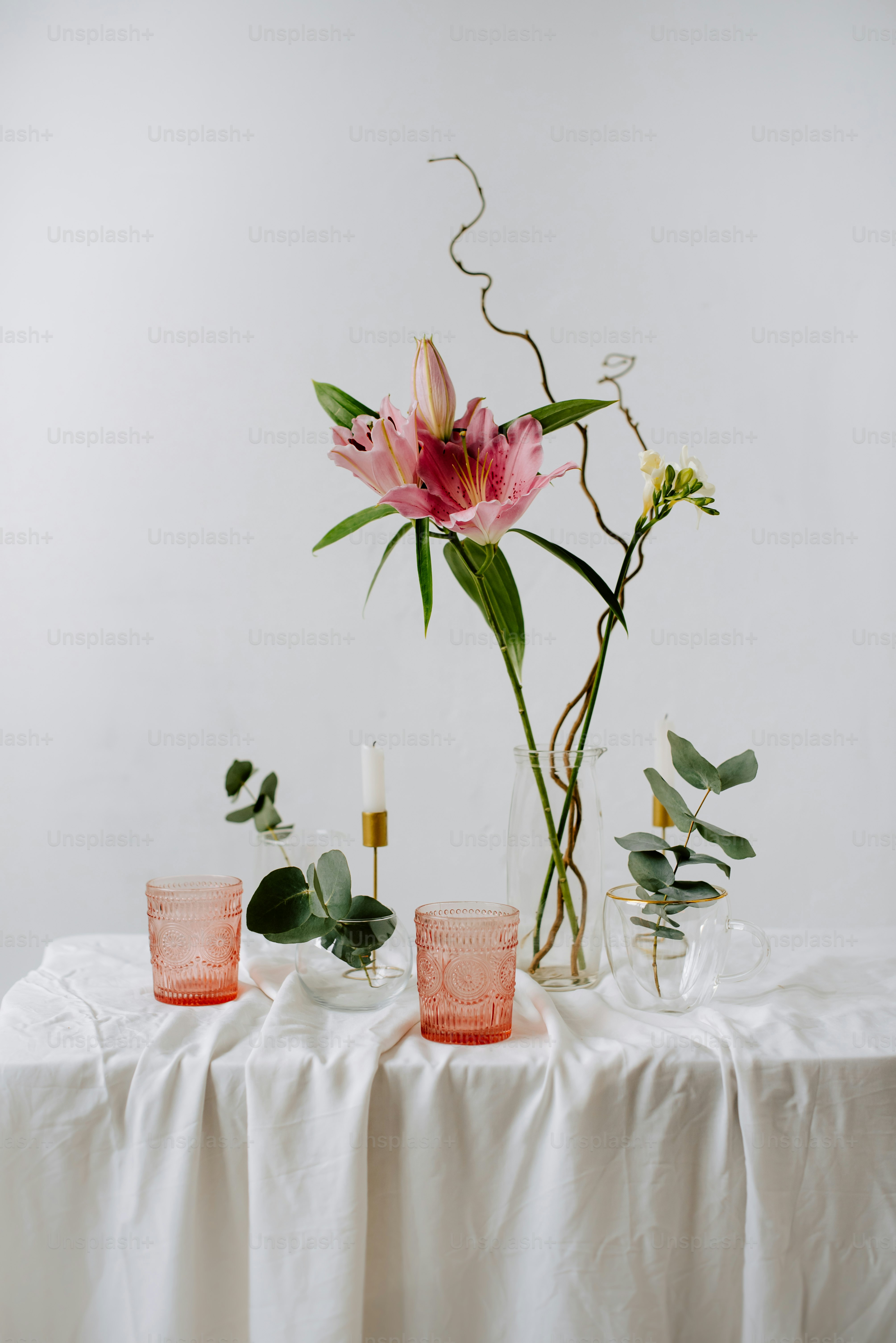 a table topped with a vase filled with flowers